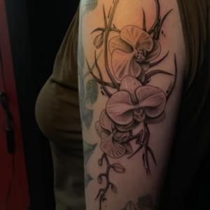 Black ink orchid tattoo wrapping around a forearm with twisting vines and subtle shading.
